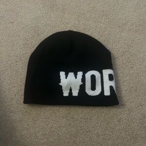 Black graphic beanie with “Worth it” print on it